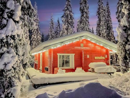 a log cabin in the snow with snow covered trees at Holiday Home Joutilas by Interhome in Ruka