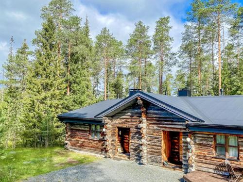 a log cabin with a black roof at Holiday Home Rantaruka 4d1 by Interhome in Ruka