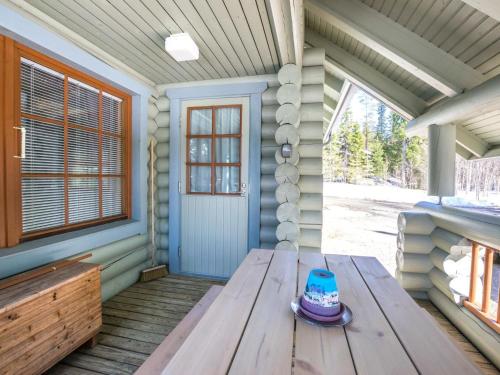 a picnic table on the porch of a house at Holiday Home Keisarintupa by Interhome in Ruka