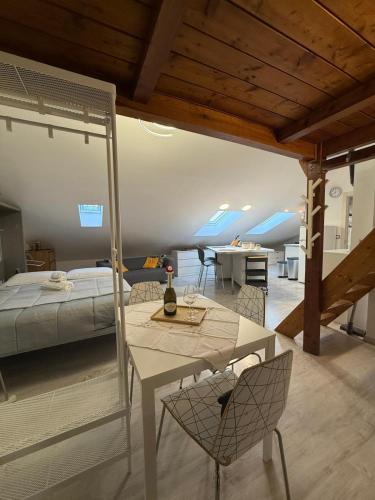 a bedroom with a bed and a table and chairs at Avigliana Einaudi in Avigliana