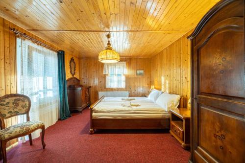 a bedroom with a bed in a wooden room at Dom Szklarski Kamień in Szklarska Poręba