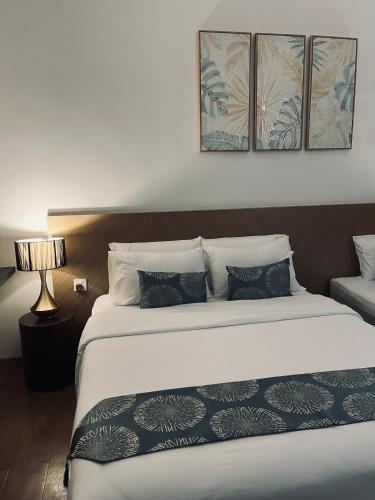 a bedroom with a large bed with four pillows at Putri Hotel at Mydin Tunjong in Kota Bharu