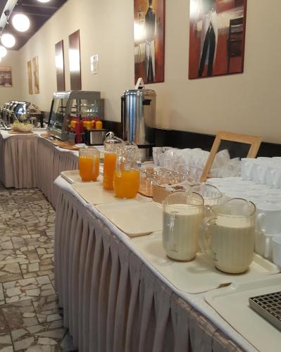 a table with glasses of orange juice on it at Ośrodek Wypoczynku i Rekreacji Venus in Mrzeżyno
