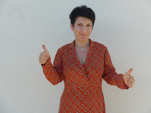 a woman in a red shirt giving the thumbs up at Maison de Luciné in Combourg