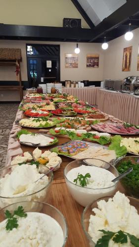 a long table filled with many plates of food at Ośrodek Wypoczynku i Rekreacji Venus in Mrzeżyno