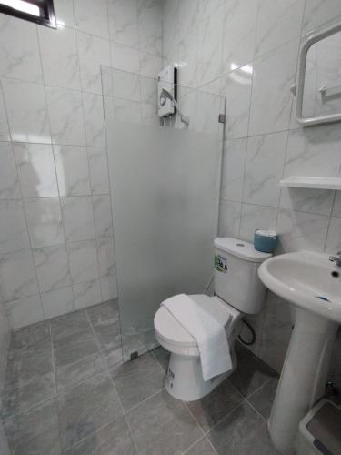 a white bathroom with a toilet and a sink at Samui Land Haven in Taling Ngam Beach