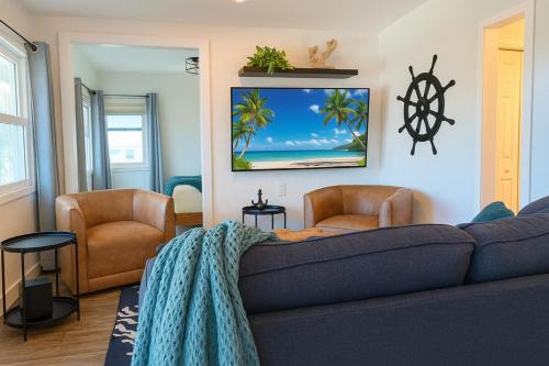 a living room with a couch and two chairs at 107 · Boat dock- BBQ Walk to Beach GREAT VIEWS in St. Pete Beach