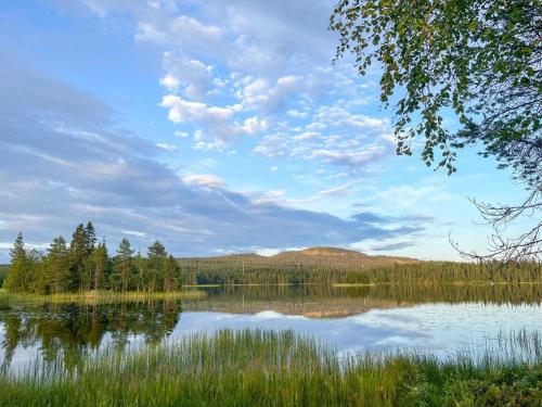 a view of a lake with trees on the shore at Holiday Home Keloveska by Interhome in Ruka