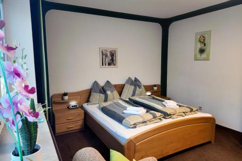 a bedroom with a bed with a wooden frame at Apartment Wurth in Groß-Siegharts