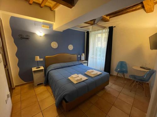 a bedroom with a bed with two towels on it at Porta Mazzini Affittacamere in Iesi