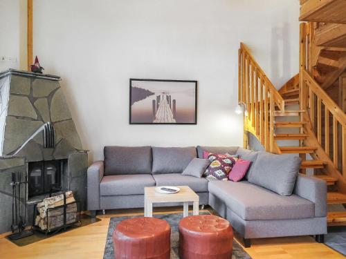 a living room with a couch and a fireplace at Holiday Home Artturi by Interhome in Levi