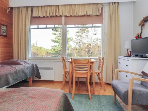 a bedroom with a table and chairs and a window at Holiday Home Moitakuru a5 by Interhome in Saariselka