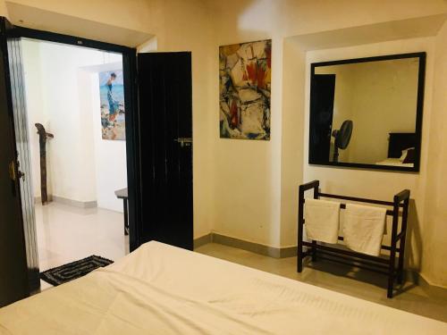 a bedroom with a bed and a large mirror at Madiha Dolamulla Gedara in Kamburugamuwa