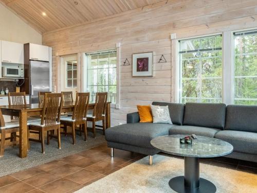 a living room with a couch and a table at Holiday Home Atrin suvanto a by Interhome in Levi