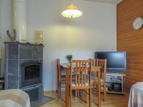 a living room with a table and a television and a table and chairs at Holiday Home Moitakuru a14 by Interhome in Saariselka