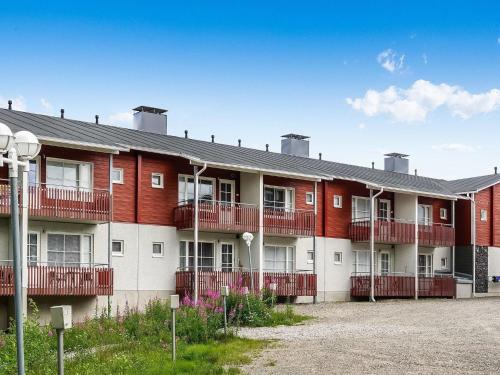 a red and white building with a lot of balconies at Holiday Home Levi star 2- as- 409 by Interhome in Levi