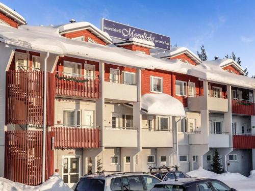 a building with cars parked in front of it at Holiday Home Levin tuisku by Interhome in Levi
