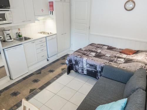 a kitchen with a bed and a couch in a room at Holiday Home Levi star 1503 by Interhome in Levi