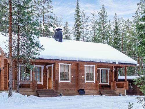 a log cabin with snow on the roof at Holiday Home Aslakit a by Interhome in Levi