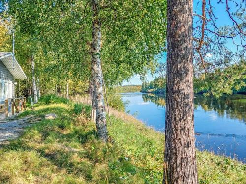 a view of a river from between two trees at Holiday Home Mukan maja by Interhome in Köngäs