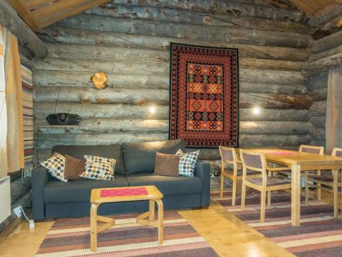 a living room with a couch and a table at Holiday Home Atokka by Interhome in Levi
