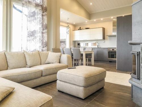 a living room with a couch and a table and a kitchen at Holiday Home Karhu b by Interhome in Saariselka