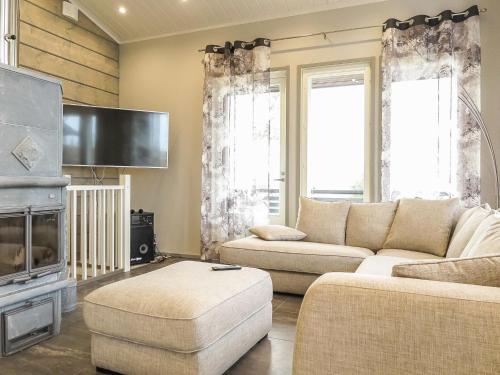 a living room with two couches and a flat screen tv at Holiday Home Karhu b by Interhome in Saariselka