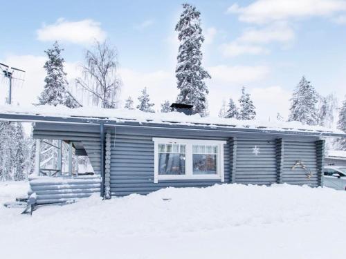 a house with snow on the roof at Holiday Home Jousimaja by Interhome in Ylläsjärvi