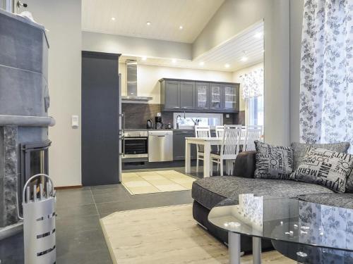 a living room and kitchen with a couch and a table at Holiday Home Karhu a by Interhome in Saariselka