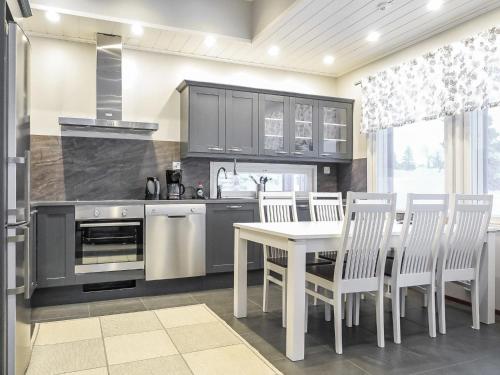 a kitchen with a table and chairs and a stove at Holiday Home Karhu a by Interhome in Saariselka