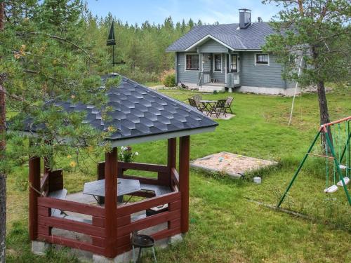 a gazebo in a yard with a house at Holiday Home Ahonlaita by Interhome in Karvonen