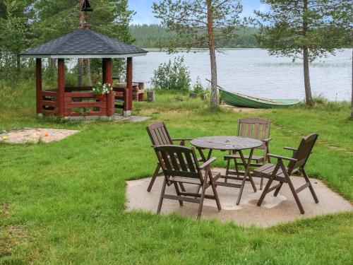 a picnic table and chairs with a gazebo and a gazeb at Holiday Home Ahonlaita by Interhome in Karvonen
