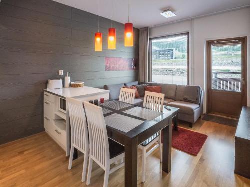 a kitchen and living room with a table and chairs at Holiday Home Ski chalet 6206 by Interhome in Ylläs