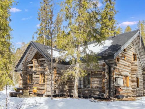 a log cabin in the woods in the snow at Holiday Home Örtsylä b by Interhome in Salla