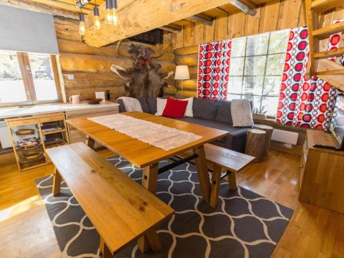 a living room with a wooden table and a couch at Holiday Home Örtsylä b by Interhome in Salla