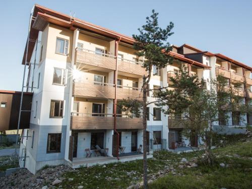 an apartment building with trees in front of it at Holiday Home Ylläs chalets 3207 by Interhome in Ylläs