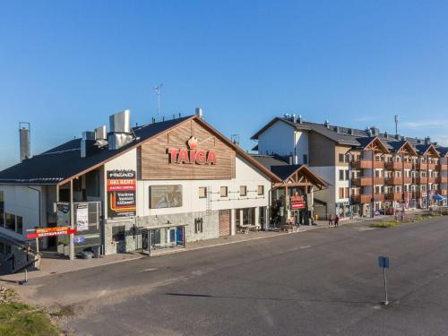 a building with a pizza sign on the side of a street at Holiday Home Ski chalets 6203 by Interhome in Ylläs