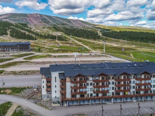 an apartment building with a mountain in the background at Holiday Home Ski chalets 6203 by Interhome in Ylläs