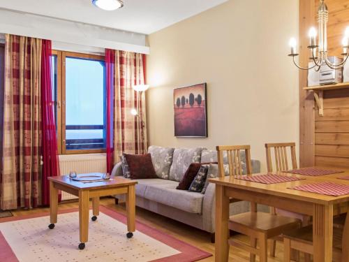 a living room with a couch and a table at Holiday Home Ylläs chalets a502 by Interhome in Ylläs