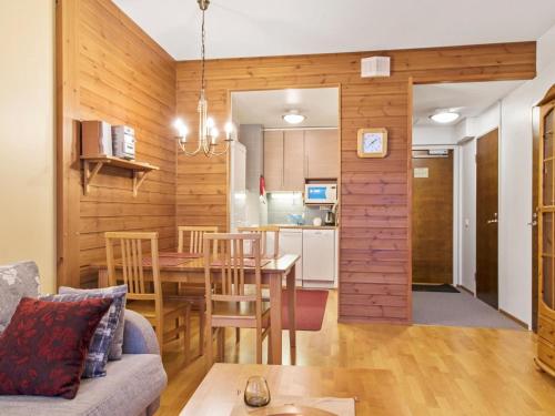 a living room and kitchen with a table and chairs at Holiday Home Ylläs chalets a502 by Interhome in Ylläs