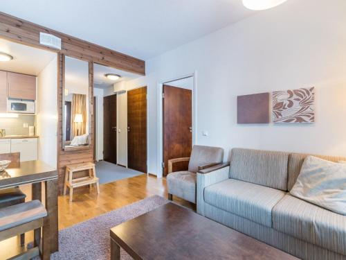 a living room with a couch and a table at Holiday Home Ylläs chalets 3210 by Interhome in Ylläs
