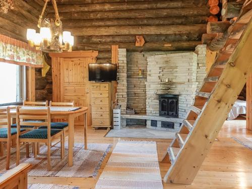 a dining room with a table and a fireplace at Holiday Home Kulpakko 2 by Interhome in Tiainen