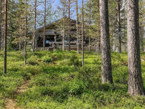 a log cabin in the woods with trees at Holiday Home Kulpakko 2 by Interhome in Tiainen