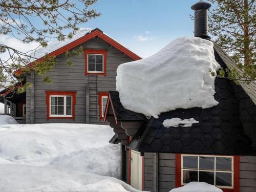 a house with snow on top of it at Holiday Home Lustola b by Interhome in Luosto