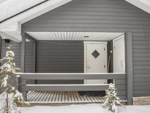 a front door of a house with a christmas tree at Holiday Home Tunturinvieri l3 by Interhome in Ylläsjärvi