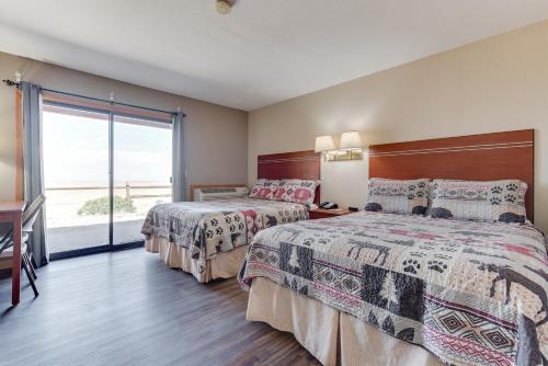 a hotel room with two beds and a large window at Great Sand Dunes Lodge in Mosca