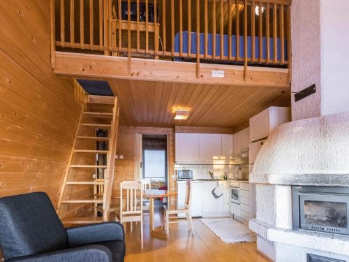 a tiny house with a loft bed and a kitchen at Holiday Home Tunturinvieri k2 by Interhome in Ylläsjärvi