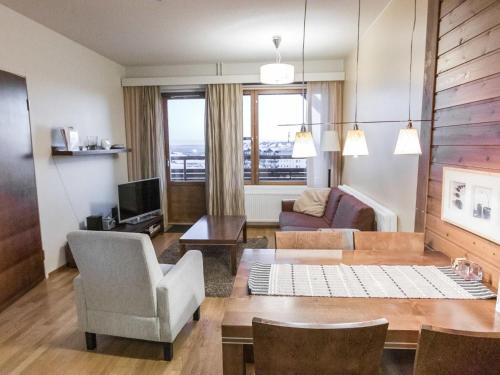 a living room with a couch and a table at Holiday Home Ylläs chalets a202 by Interhome in Ylläs