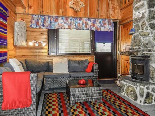 a living room with a couch and a fireplace at Holiday Home Kantapää c 3 by Interhome in Luosto