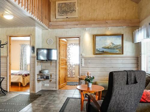 a living room with a couch and a table at Holiday Home Lustola a by Interhome in Luosto